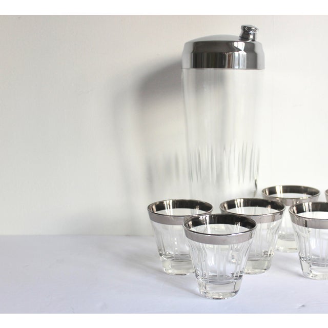 Fabulous mid century modern cocktail set. Includes a large cocktail shaker with deeply etched lines and a metal top and...