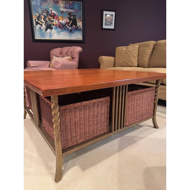 A square coffee table with a solid quarter-sawn oak top showing strong ray-fleck figure, on an antiqued gold/bronze iron...