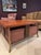 A square coffee table with a solid quarter-sawn oak top showing strong ray-fleck figure, on an antiqued gold/bronze iron...