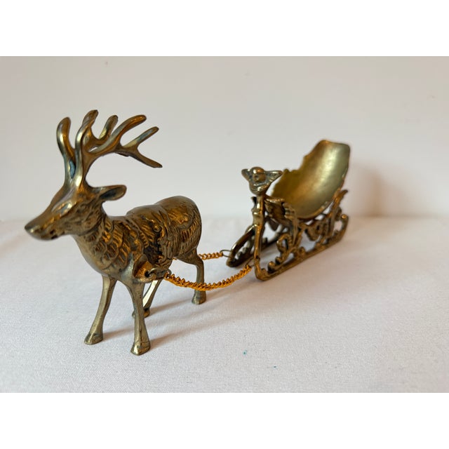 Vintage Solid Brass Reindeer & Sleigh. The sleigh can hold candy, greenery or tiny little packages. The bow of the sleigh...