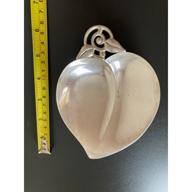 A beautiful and shiny Tiffany & Co sterling silver dish, circa mid 20th century, USA. Heart shaped jewelry dish with clean...