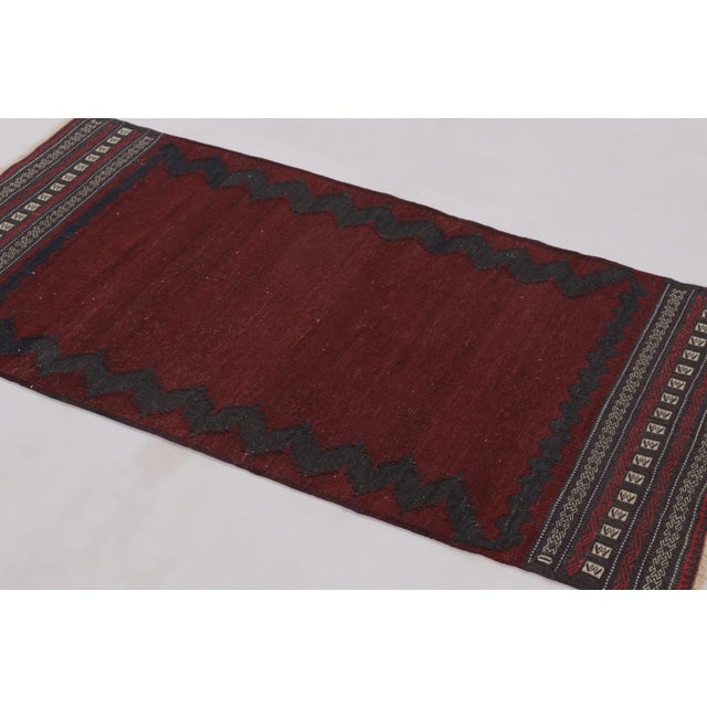 Hand-woven in wool circa 1950-1960, this 2x5 vintage Persian flat-weave runner Kilim is a beautiful example of tribal...