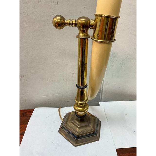 This is a neoclassical style desk or table lamp that is a faux horn mounted to a brass support. It is adjustable by the...