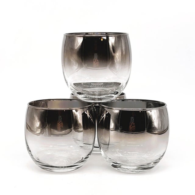 A sophisticated set of four vintage roly poly glasses by Libbey, featuring an elegant silver fade finish characteristic of...