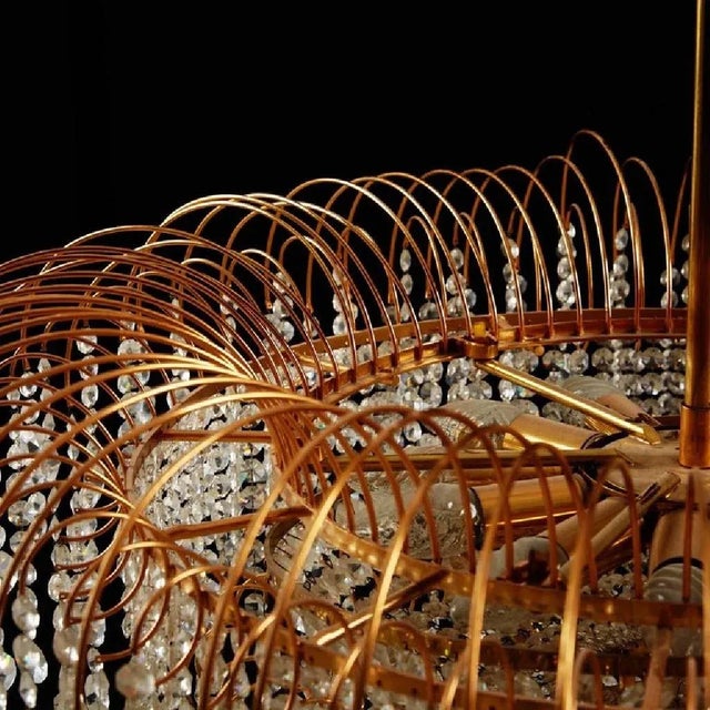 This chandelier was made circa 1976 in Sweden. It features a gold-plated brass frame with twelve E14 and E27 sockets....