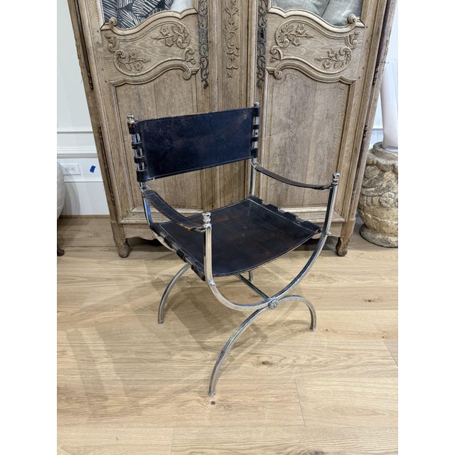 Add timeless elegance and sculptural appeal to your home with this striking pair of black leather Savonarola chairs....