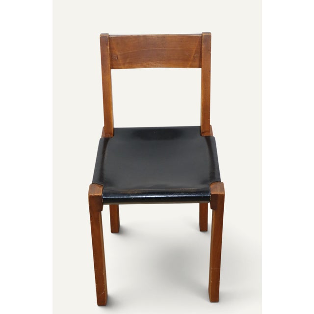 Model S24 chair, designed by Pierre Chapo in 1967, combining a solid elm frame with a black leather seat. Particularly...