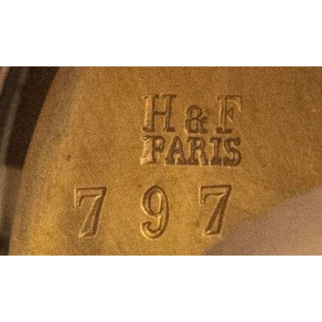 An imposing and highly distinctive three-piece garniture de cheminée, signed H&F Paris, featuring a remarkable decorative...