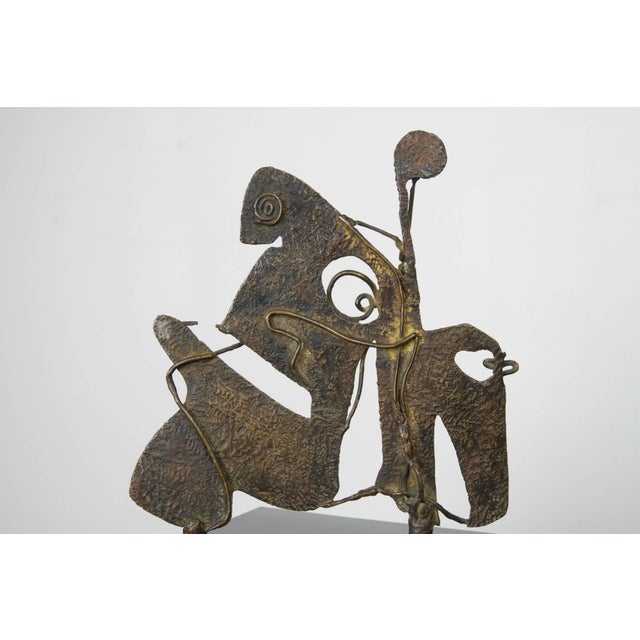 A fine small-scale metal and wire sculpture in the manner of Picasso, depicting a bull and rider in two dimensions,...