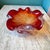 A spectacular large chunky hand blown Murano glass style bowl with a deep red color and silver leaf flecks running...