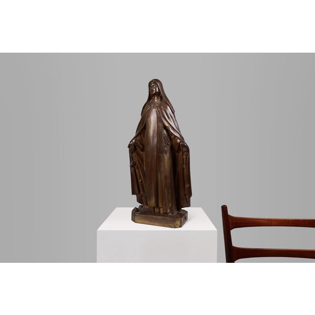 A graceful statue of the Holy Mary in bronze painted plaster in Art Deco style. Crafted in Belgium in the 1930s. Virgin...