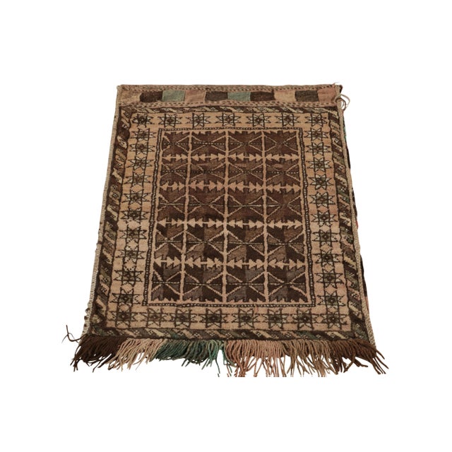 Paying tribute to the nomadic sensibilities of Baluchistan, a 2x3 antique Baluch rug coming from Persia circa 1920-1930....