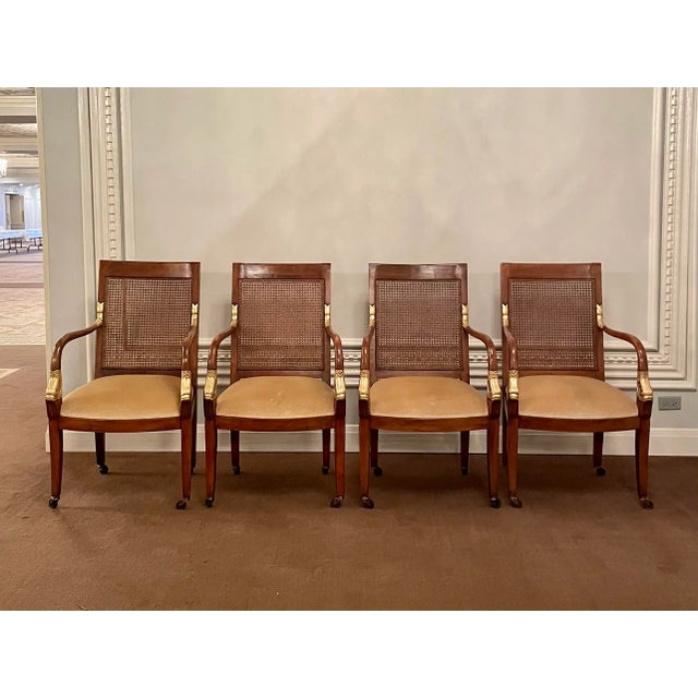 Set of 4 French Empire style armchairs with golden beige mohair upholstery seats, circa mid-20th century. Each solidly...