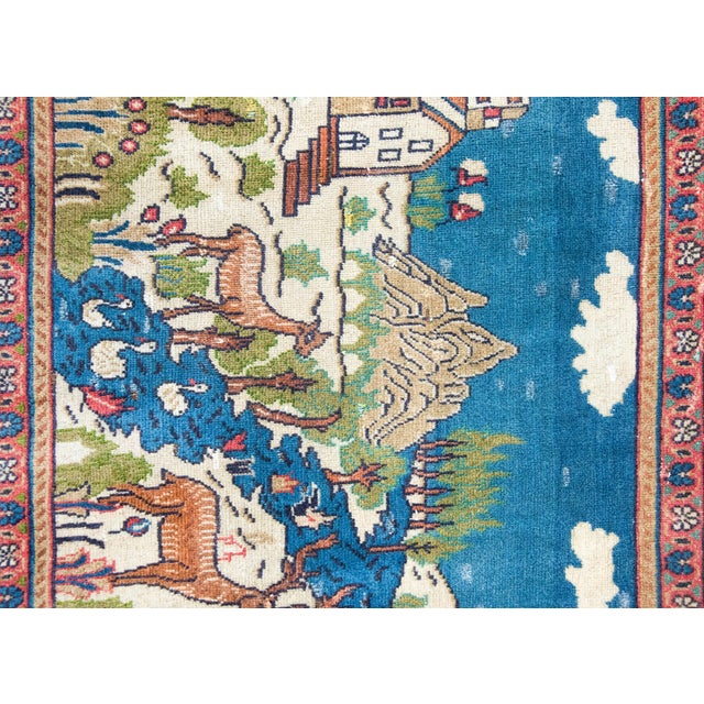 A wonderfully charming early 20th century Persian Pictorial Tabriz rug depicting two deer standing at the edge of a river...