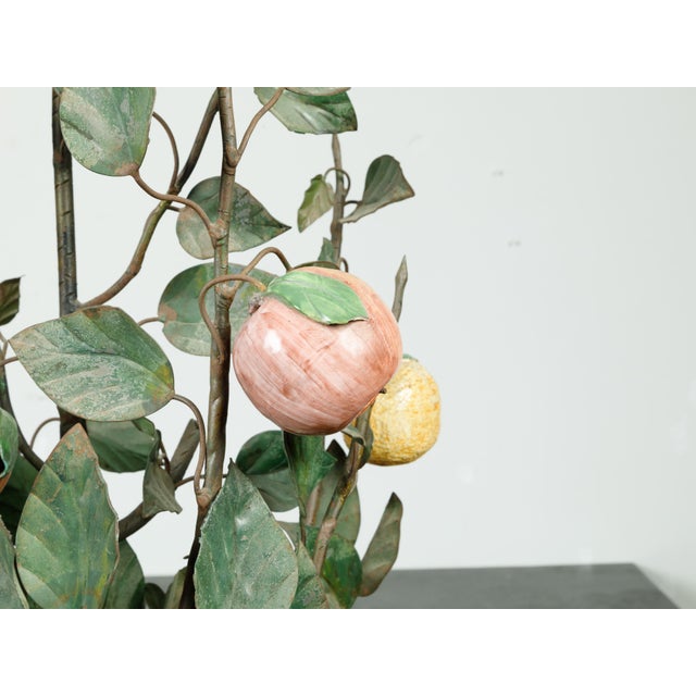 A French tôle and glass tree in pot from the mid 20th century, with orange and yellow fruits. Created in France during the...