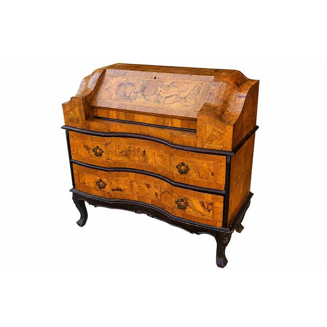An elegant venetian-style walnut and burl walnut veneered drop-leaf cabinet, crafted in the 19th century, characterized by...