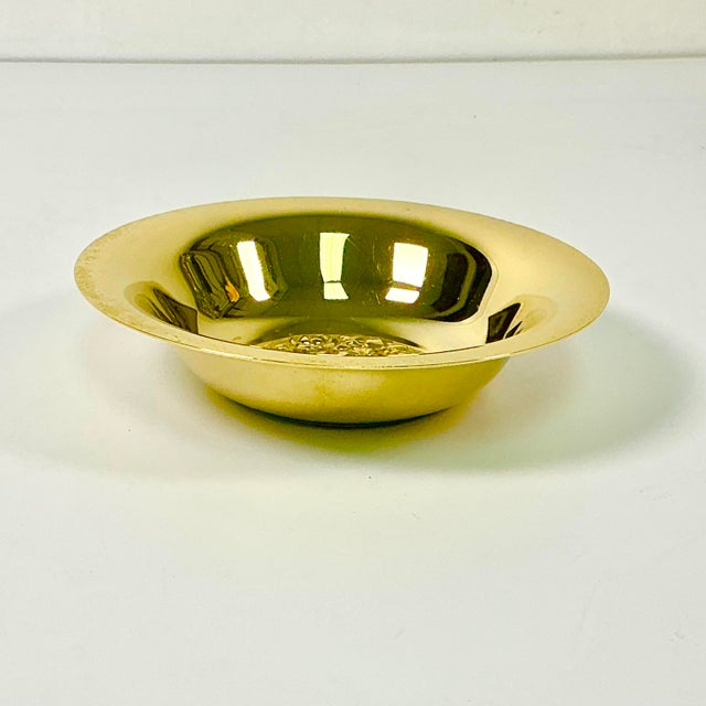 This pretty gold-plated candy dish features a raised flora design in the center bowl. the rest of the bowl is smooth. It's...