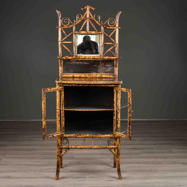 Found and originating in England, this bamboo framed cabinet dates from approximately 1890. The Aesthetic Movement era...