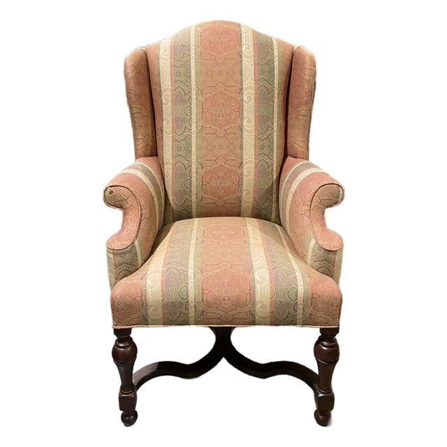 Late 20th Century Traditional Wingback Armchair in Warm Patterned Fabric With Carved Wood Base For Sale