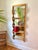 Is it a mirrored shelf or a shelfed mirror? Whimsical wavy four-tiered shelf and mirror made of heavy wood construction,...