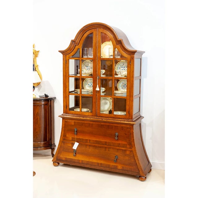 Handcrafted in Italy from solid walnut, this elegant display cabinet features an antique distressed finish and classic...