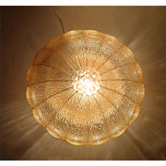 A stunning pair of of ambiental art masterworks, created in the 80s, made of amber glass on gold painted metal support, a...