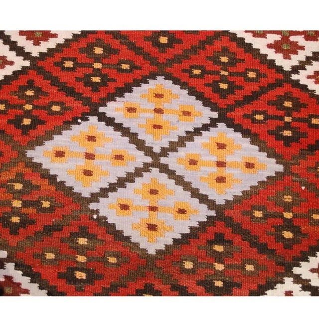 An early 20th Century, circa 1940, Persian Saveh runner with brilliant diamond pattern of alternating multicolored...