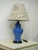 Add some Hollywood chic style to your space with this blue ginger jar regency style table lamp. The lamp has a French...