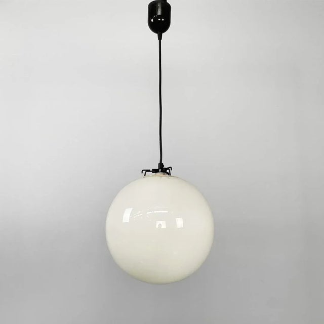 Italian mid century round white glass chandelier, 1950s Round chandelier with spherical diffuser in white glass. The...