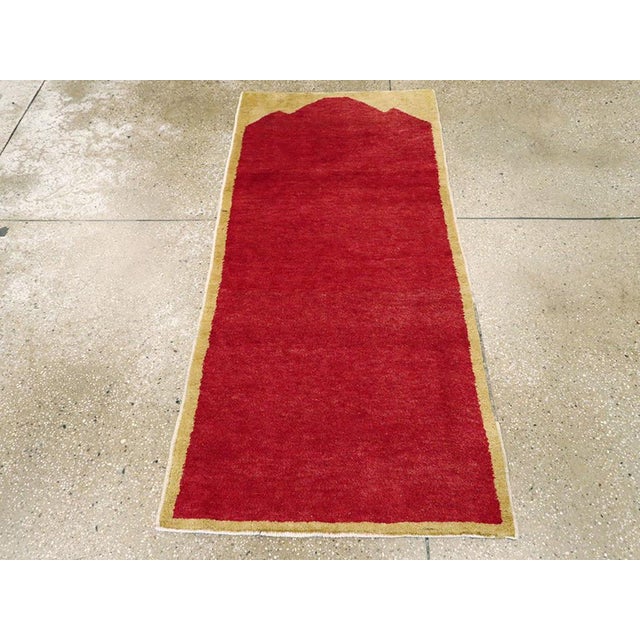 A vintage Turkish Anatolian throw rug. Two colors: red and sandy beige. A triple pointed tall plain red niche bends to a...