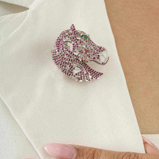 This horse-head brooch features 4.1 carats of ruby set in 925 sterling silver, creating a bold and luxurious statement...