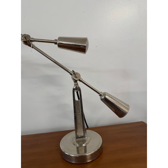 Elevate your workspace with the timeless, industrial sophistication of the Ralph Lauren Home RL '67 Boom Arm Desk Lamp....