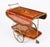 This is a very entertaining vintage two-tier walnut Italian Sorrento drinks trolley, mid-century in date. The rectangular-...