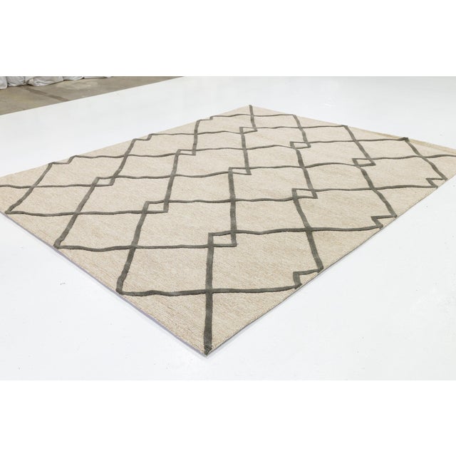 Elevate your living space with this sophisticated Modern Hand-Tufted Wool Rug, featuring a bold, oversized diamond trellis...