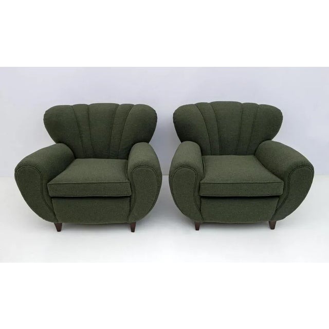 Pair of Italian sculptural armchairs designed by Guglielmo Ulrich, very comfortable. Recently covered in green Bouclè,...
