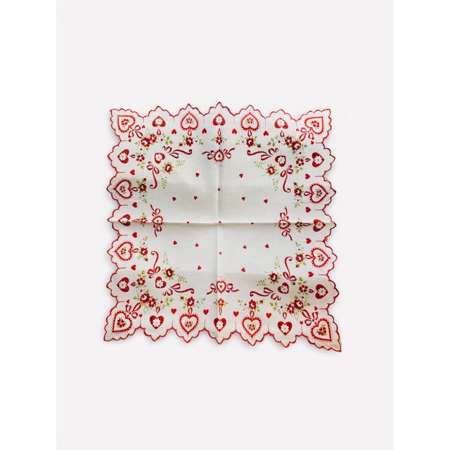 A pair of 1950s printed linen Valentines handkerchiefs decorated with red hearts, flowers, and ribbons. Scalloped red...