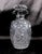 This is an oval cut crystal decanter that has an unusual clam shell shaped top/spout. It includes a stopper that may not...