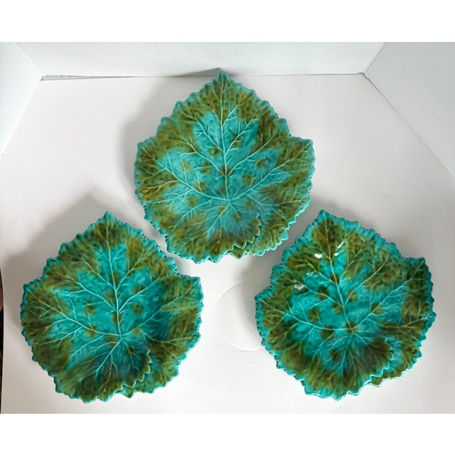 This vintage set of six majolica leaf plates was likely produced in Portugal, circa 1960s. The plates feature beautifully...
