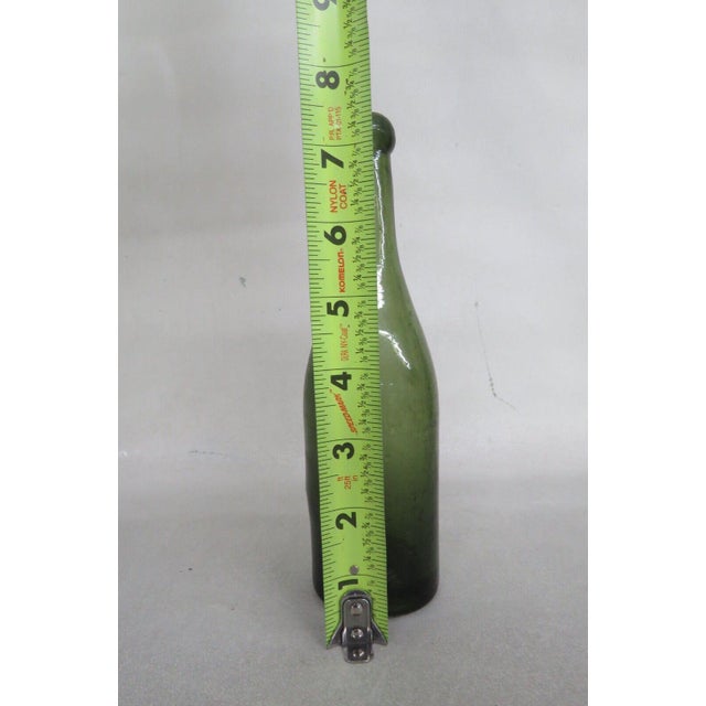 This is a simplistic bottle with a nice olive green color. The lip of the bottle is a wider and more rounded from the neck...