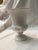 Elegant Wedgewood, pedestal urn vase featuring a flared rim, ribbed lower body, and applied shell handles. Finished in a...