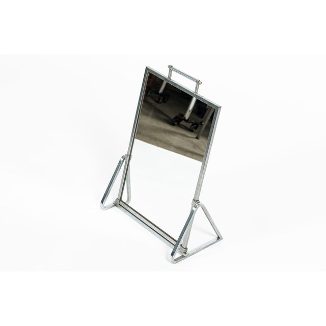 This vintage antique Art Deco modernist tabletop vanity mirror dates to the 1930s. The mirror features a heavy, expertly-...