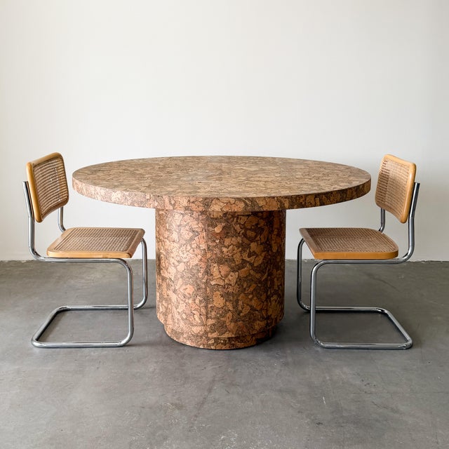 A beautifully crafted vintage round dining table showcasing the warmth and organic character of natural cork. Constructed...