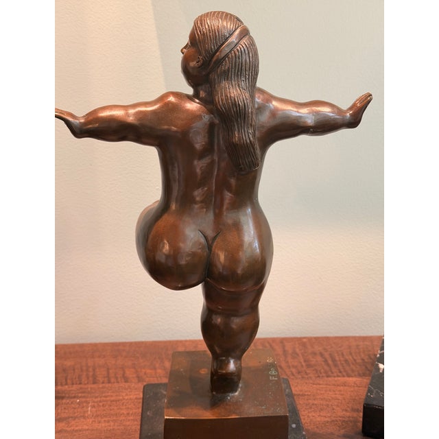 Inspired by the celebrated sculptural language of Fernando Botero, this striking after Botero bronze-patina figurative...
