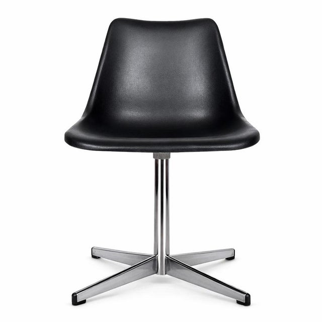 A classic vintage Robin Day swivel chair, showcasing the clean, functional design that made Robin Day one of Britain’s...