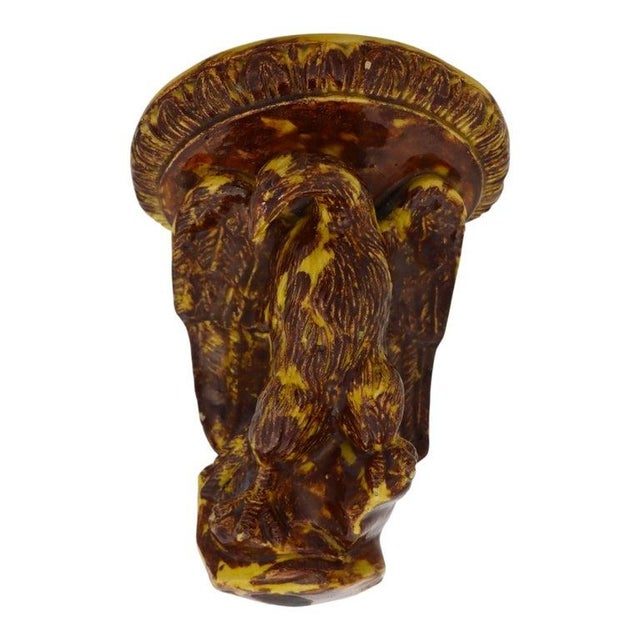 This antique Rockingham attr pottery piece is a figural stoneware corner wall sconce. It features a detailed eagle motif,...