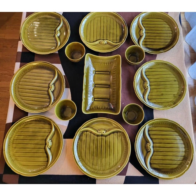 The Vintage Olive Green Earthenware Barbotine Dinnerware Set from Gien, France (set of 13) consists of 8 compartmentalized...