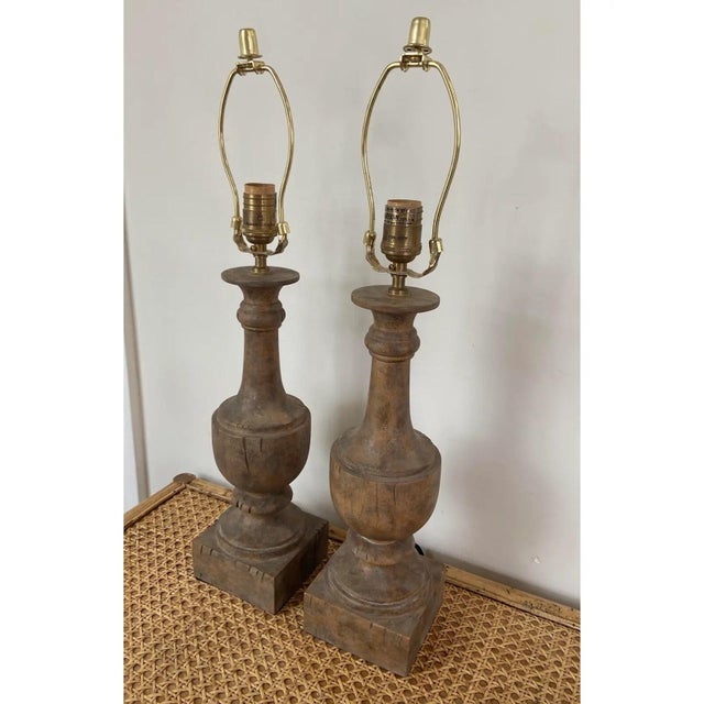 Vintage pair of carved wood baluster style lamps with original custom lamp shades by Aidan Gray. The lamps have a warm,...