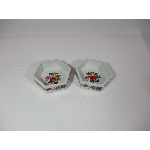 Set of two French porcelain octagon shaped snack bowls. The bowls are hand painted and decorated with flowers and fruit....