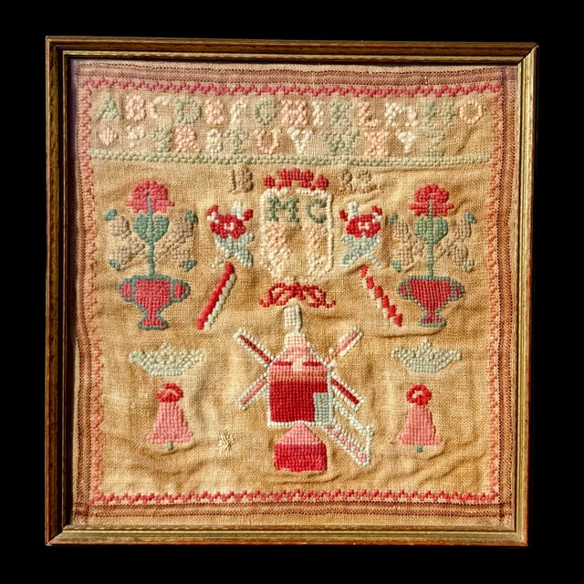 This antique needlework sampler is a hand-embroidered textile traditionally made as part of a young girl’s education...