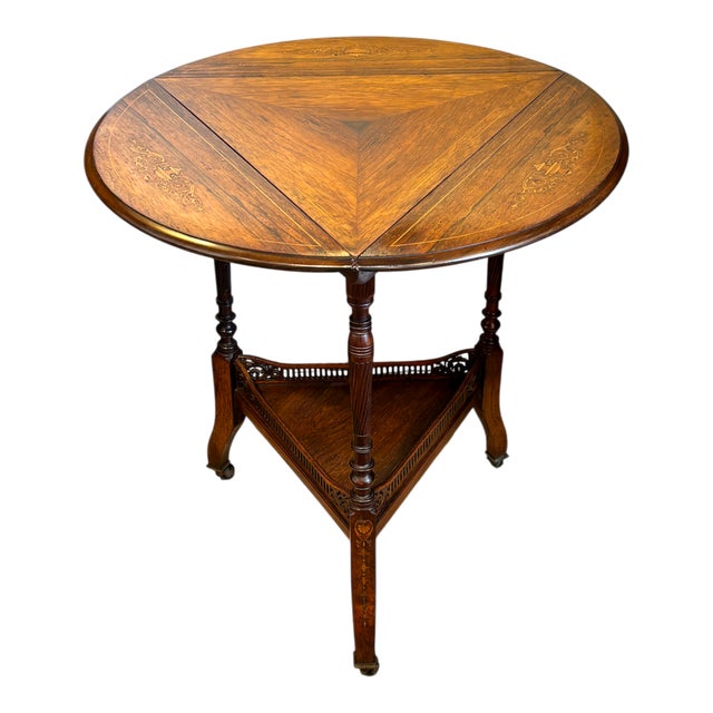 This unusual and stunning side table is a masterclass of English Victorian craftsmanship. The triangular top is comprised...